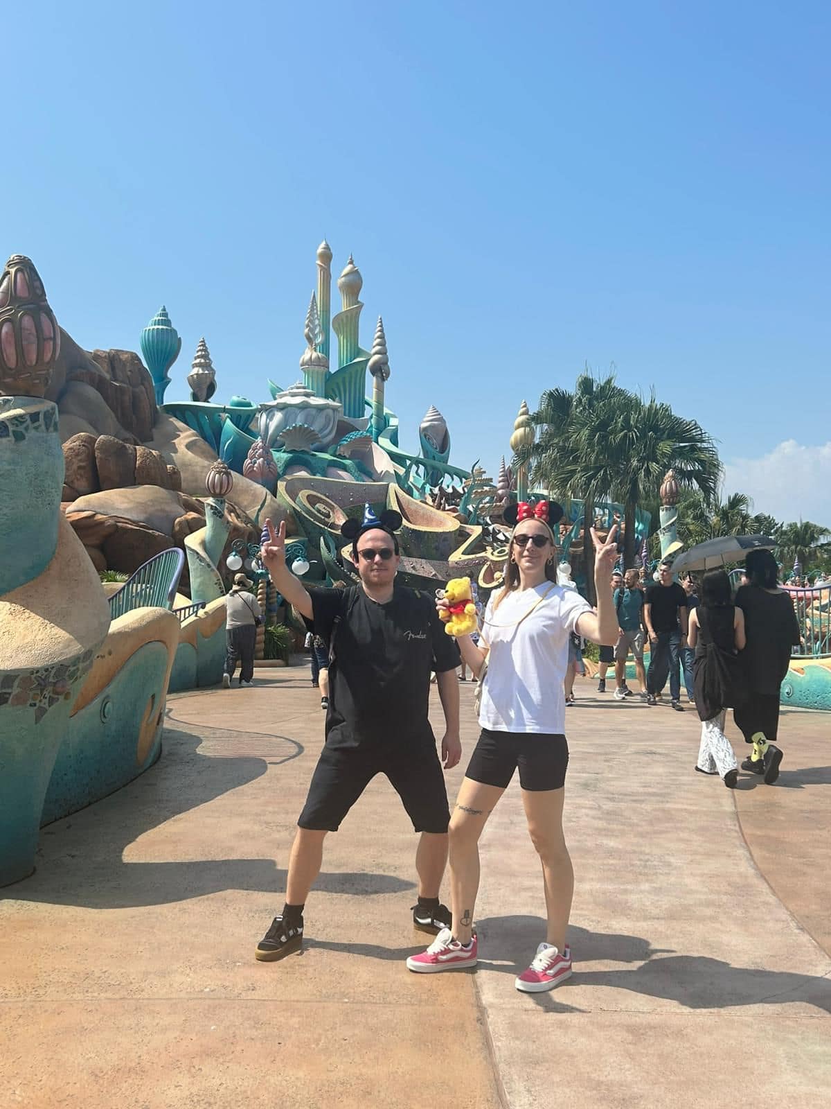 Visitors enjoying Tokyo DisneySea during the day with themed scenery