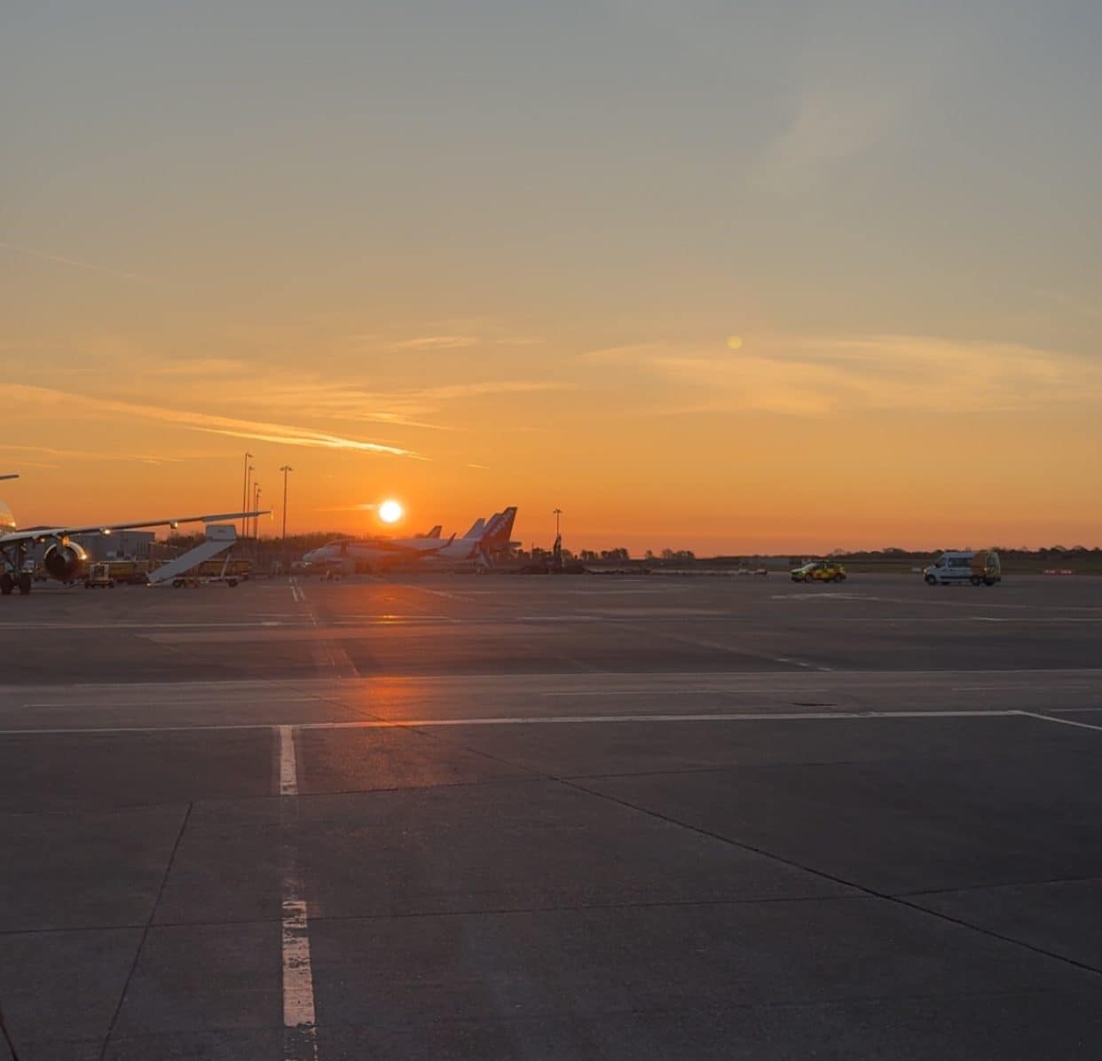 Planes on a runway at sunset before a long haul flight