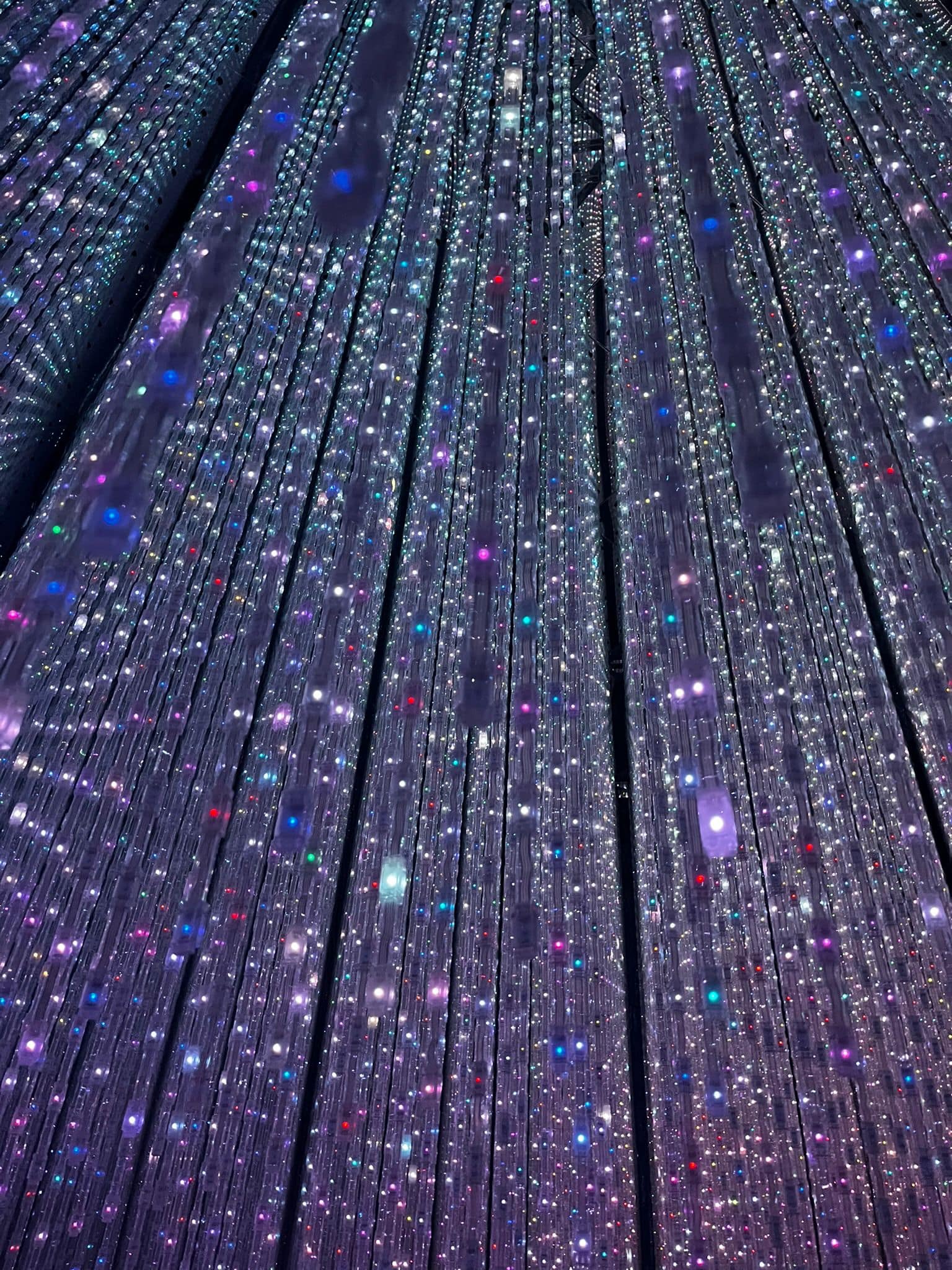 Hanging lights creating a sensory experience at TeamLab