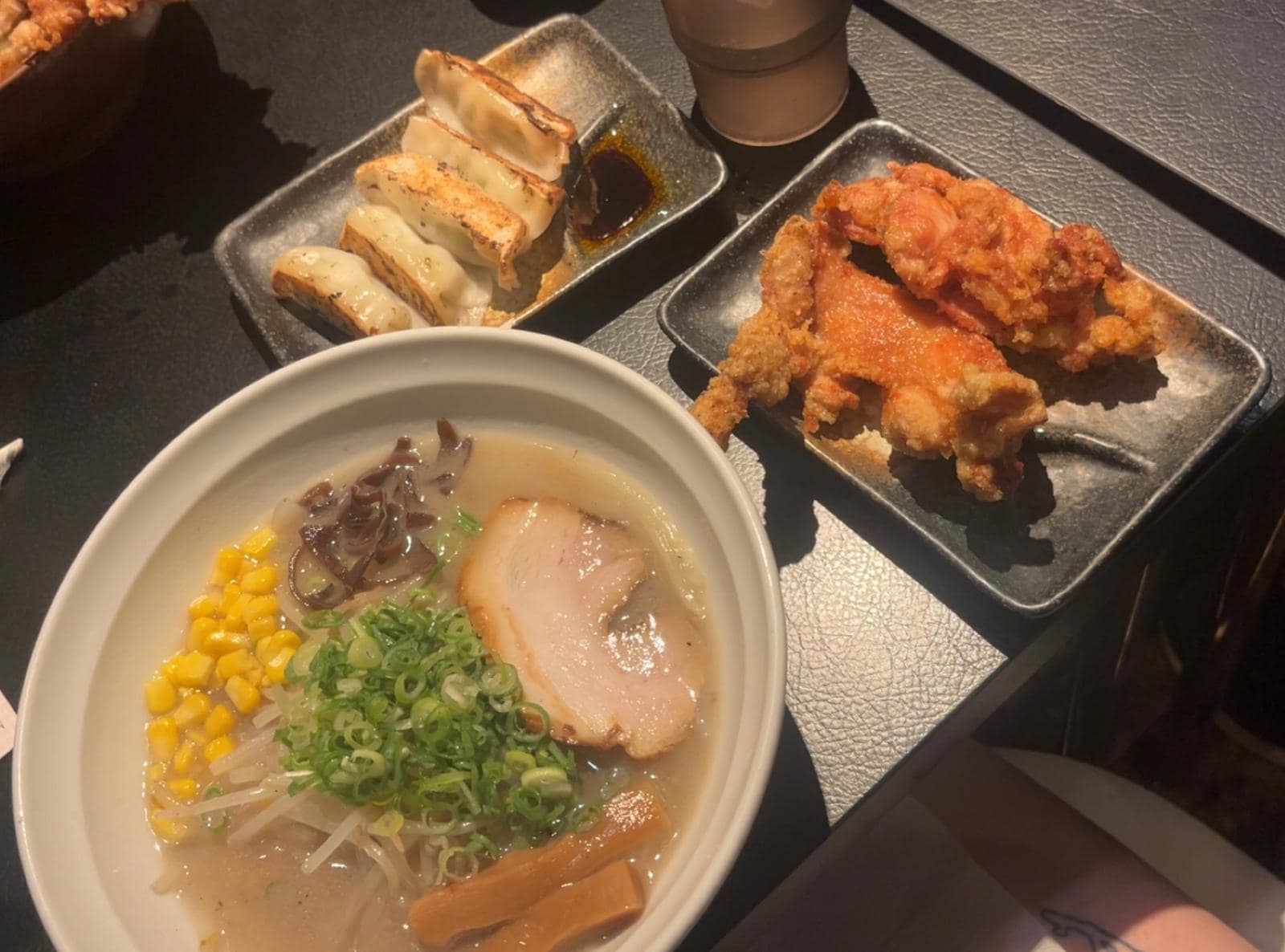Bowl of ramen with toppings and side dishes in Tokyo restaurant