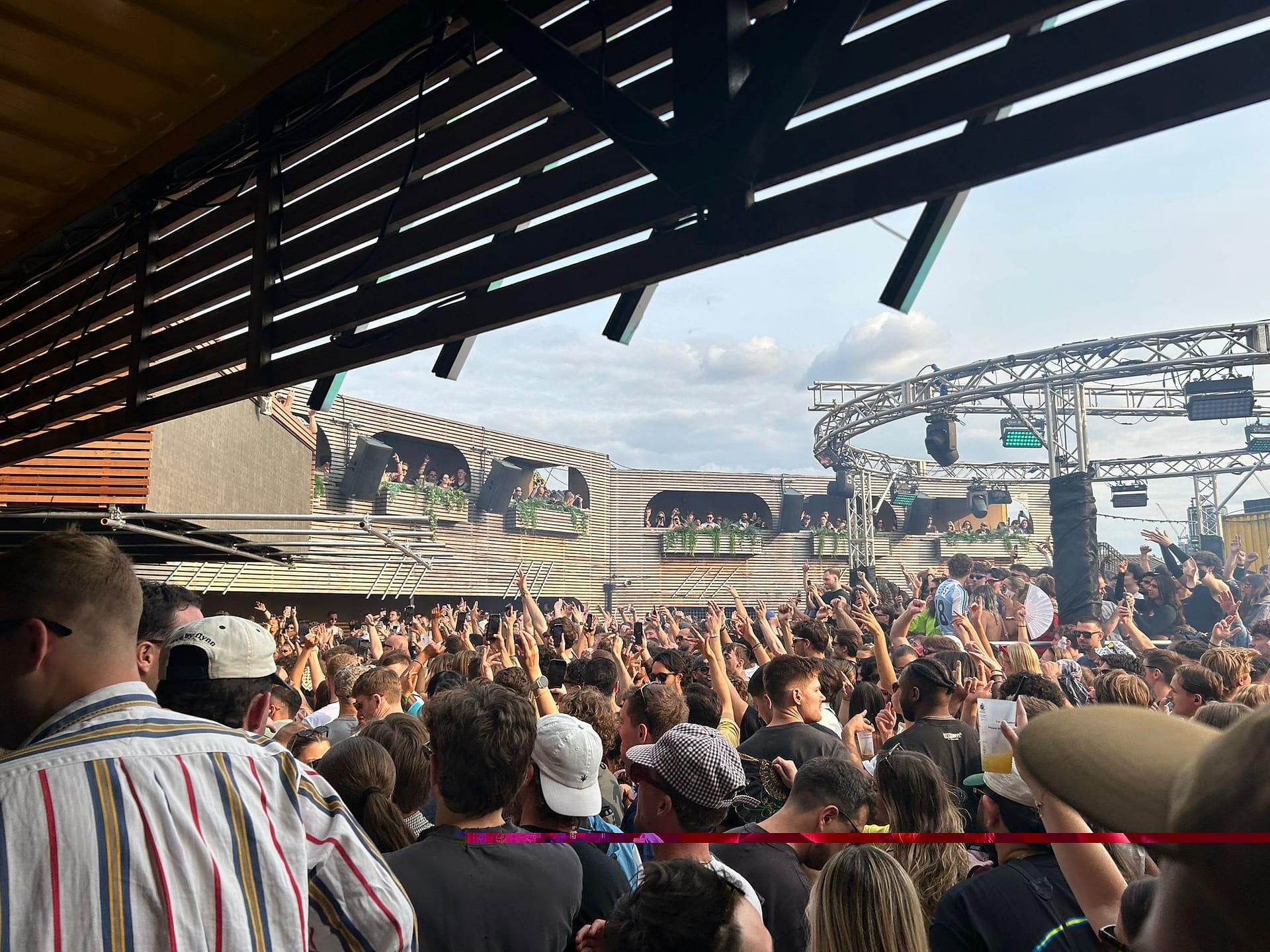Crowd dancing at an outdoor daytime DJ event in London